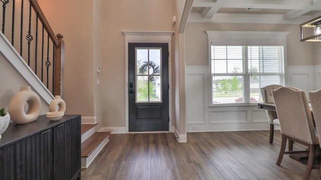 entryway featuring dark wood-style flooring, beamed ceiling, coffered ceiling, and a decorative wall