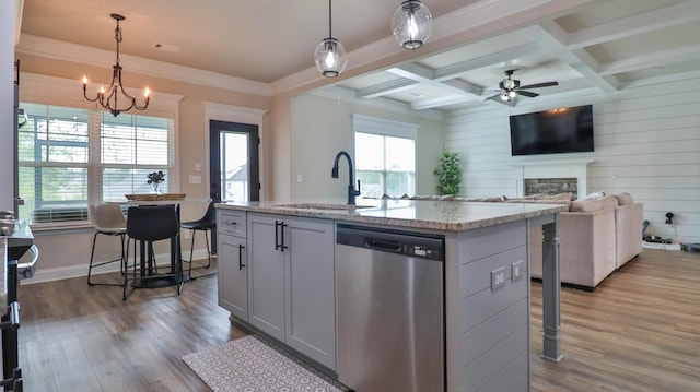 kitchen featuring gray cabinets, a fireplace, dishwasher, a sink, and ceiling fan with notable chandelier