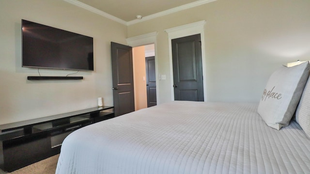 bedroom with ornamental molding and carpet