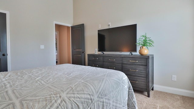 bedroom with baseboards, carpet, and a towering ceiling