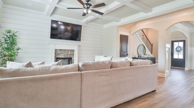 living room with a ceiling fan, beamed ceiling, wood finished floors, and coffered ceiling
