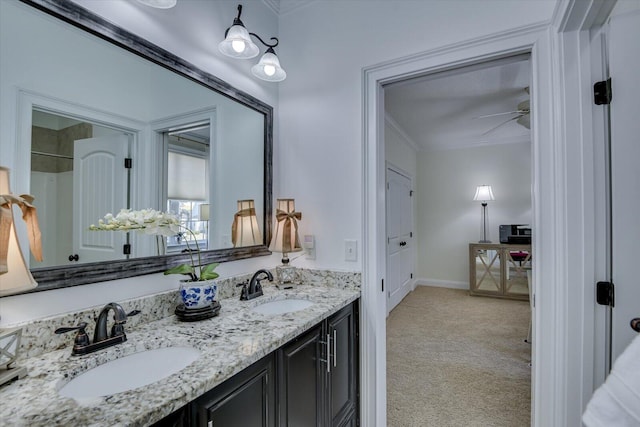 bathroom featuring a sink, a ceiling fan, double vanity, and crown molding