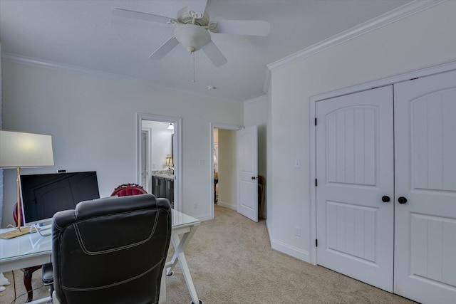 home office with light carpet, baseboards, ceiling fan, and ornamental molding