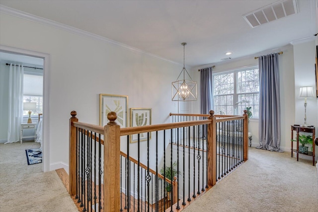 corridor with an upstairs landing, visible vents, light carpet, and an inviting chandelier