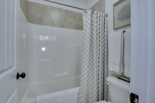 bathroom with a shower with shower curtain and toilet