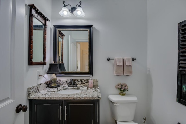 bathroom with toilet and vanity