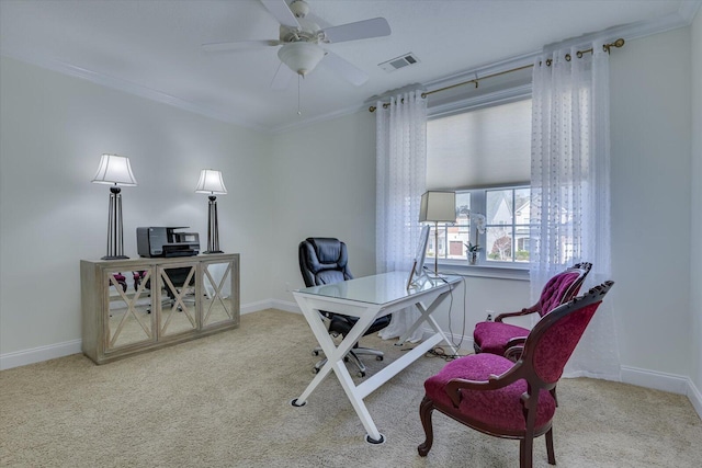 office space with visible vents, carpet, crown molding, baseboards, and ceiling fan