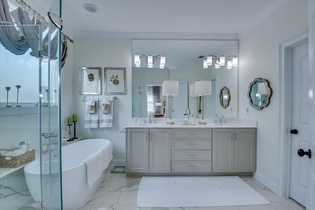 full bath featuring marble finish floor, ornamental molding, a sink, double vanity, and a freestanding bath