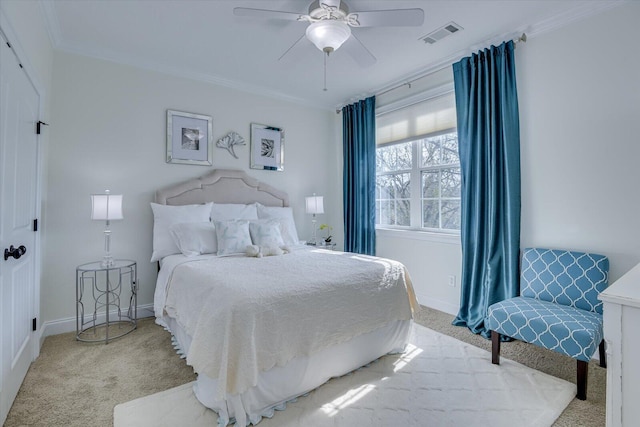 bedroom with crown molding, carpet flooring, baseboards, and visible vents