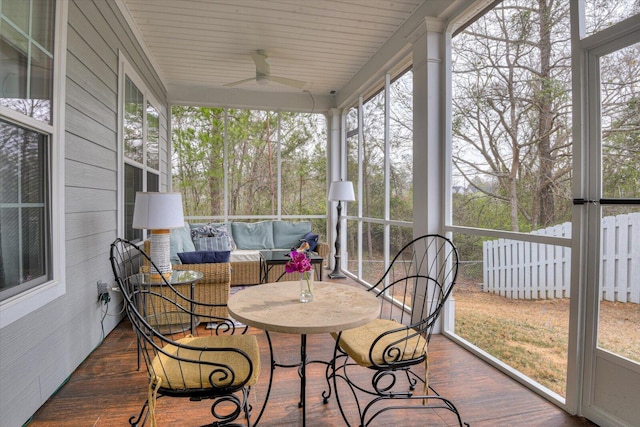 sunroom / solarium with a ceiling fan