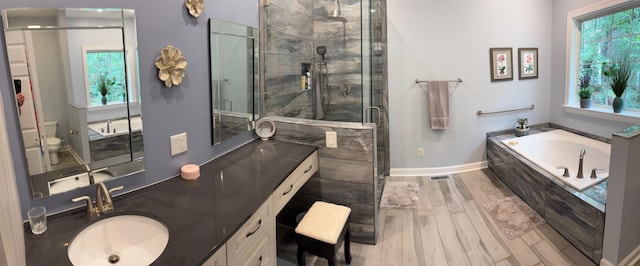 405 Sawgrass Cv, Mccormick, SC 29835 - bathroom featuring plenty of natural light, a shower stall, double vanity, and a garden tub