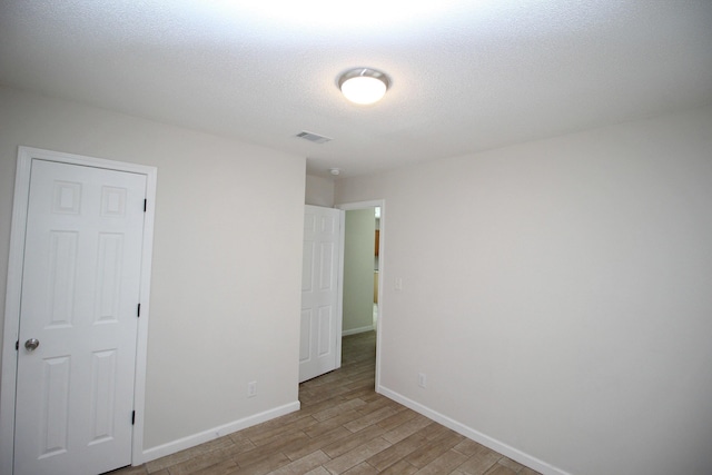 3629 Meadowgrove Dr, Augusta, GA 30906 - unfurnished bedroom with a textured ceiling, baseboards, visible vents, and light wood-style flooring