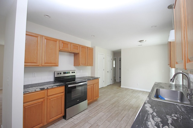 3629 Meadowgrove Dr, Augusta, GA 30906 - kitchen with a sink, baseboards, light wood-style flooring, and stainless steel range with electric stovetop