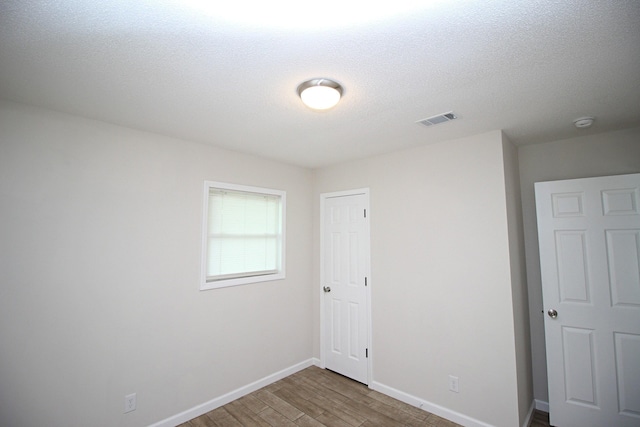 3629 Meadowgrove Dr, Augusta, GA 30906 - empty room with a textured ceiling, baseboards, visible vents, and wood finished floors