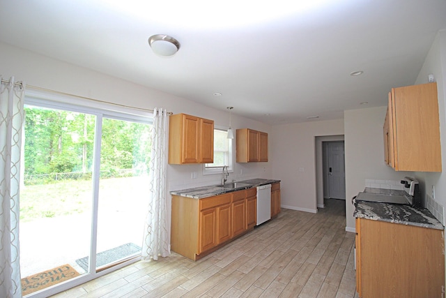 3629 Meadowgrove Dr, Augusta, GA 30906 - kitchen featuring baseboards, dark stone countertops, a sink, light wood-style flooring, and dishwasher