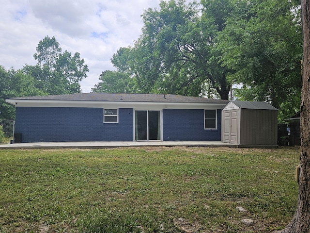 3629 Meadowgrove Dr, Augusta, GA 30906 - back of property featuring a lawn, brick siding, an outbuilding, and a storage unit