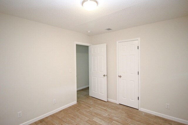 3629 Meadowgrove Dr, Augusta, GA 30906 - unfurnished bedroom featuring light wood-style floors, a textured ceiling, baseboards, and visible vents
