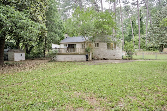 rear view of house with a shed, a chimney, an outbuilding, crawl space, and a wooden deck