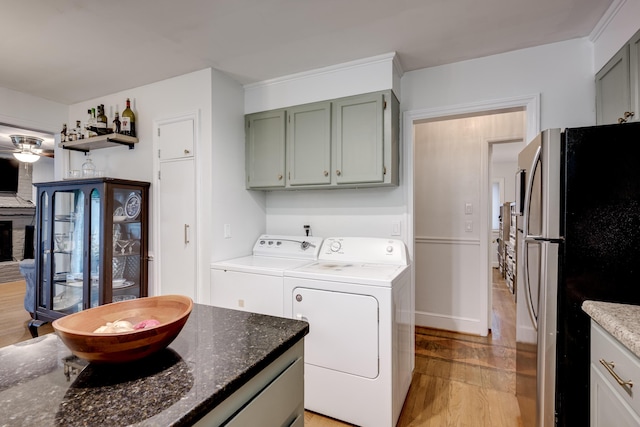 laundry room with separate washer and dryer and light wood-type flooring