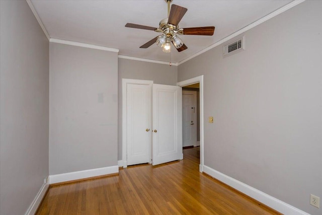 2068 Walton Way, Augusta, GA 30909 - spare room with wood finished floors, a ceiling fan, and ornamental molding