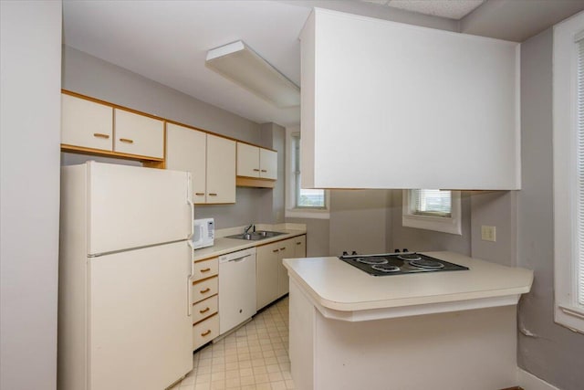 2068 Walton Way, Augusta, GA 30909 - kitchen with white appliances, light floors, light countertops, a peninsula, and white cabinets
