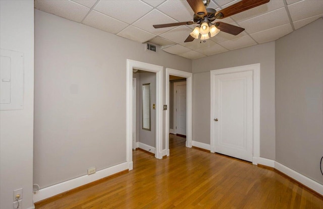 2068 Walton Way, Augusta, GA 30909 - unfurnished bedroom featuring light wood-type flooring, a drop ceiling, electric panel, and ceiling fan