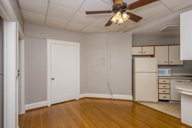 2068 Walton Way, Augusta, GA 30909 - kitchen with white appliances, a drop ceiling, light countertops, light wood-style flooring, and a ceiling fan
