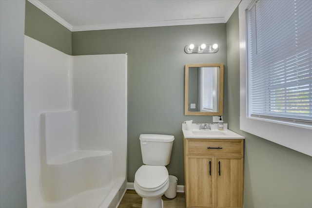 bathroom with vanity, a shower, toilet, and crown molding