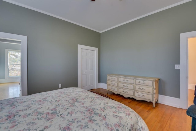 bedroom with light hardwood / wood-style floors and ornamental molding