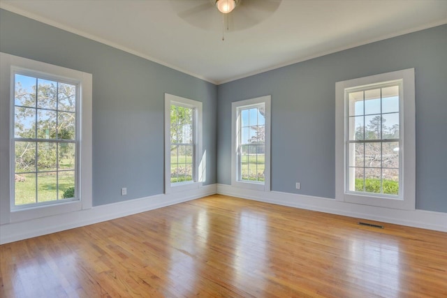 unfurnished room with ceiling fan, plenty of natural light, and light wood-type flooring