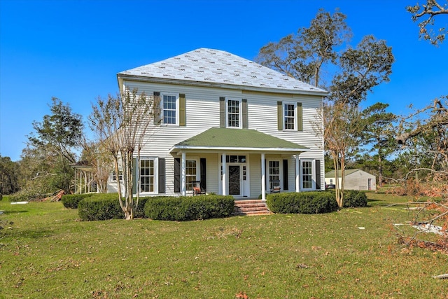 colonial inspired home with a porch and a front lawn