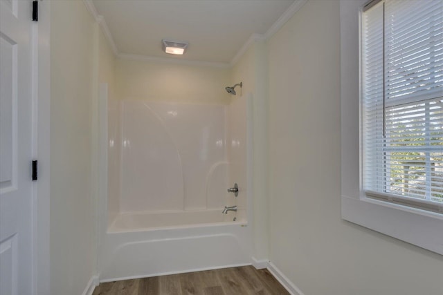 bathroom featuring crown molding, shower / bathing tub combination, and wood-type flooring