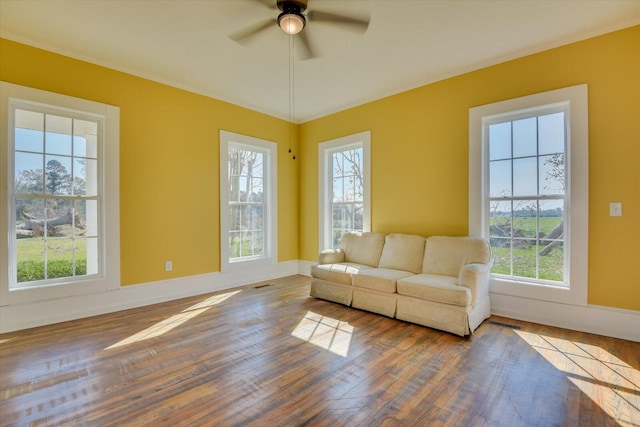 unfurnished living room featuring hardwood / wood-style flooring and ceiling fan
