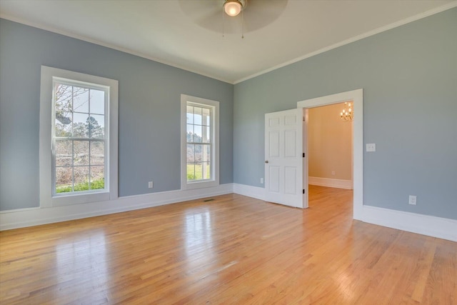 unfurnished room with a healthy amount of sunlight, crown molding, and light hardwood / wood-style flooring