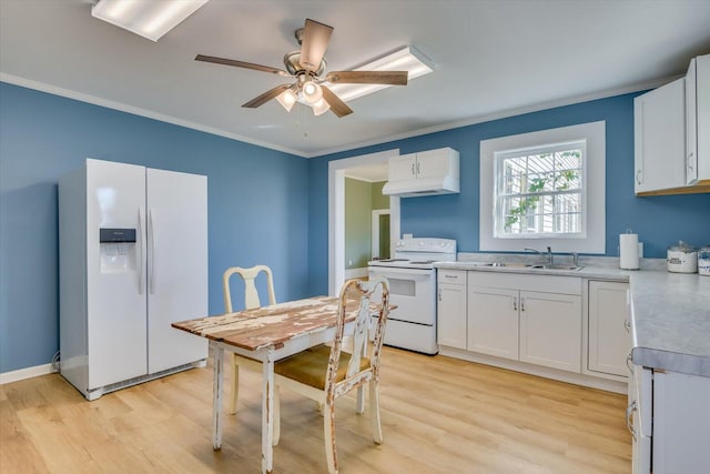 kitchen featuring white cabinetry, sink, white appliances, and light hardwood / wood-style flooring