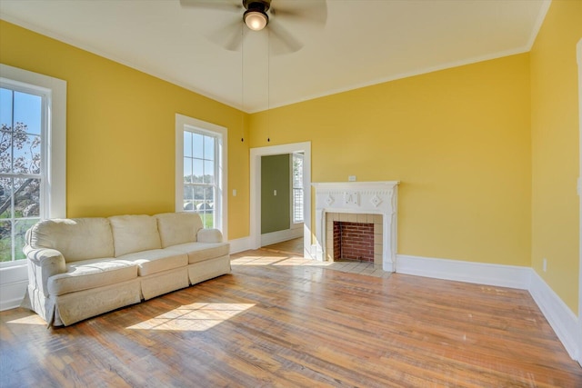 unfurnished living room with ceiling fan, crown molding, and light hardwood / wood-style floors