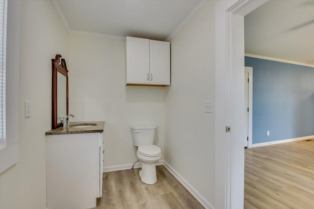 bathroom featuring crown molding, hardwood / wood-style floors, and vanity