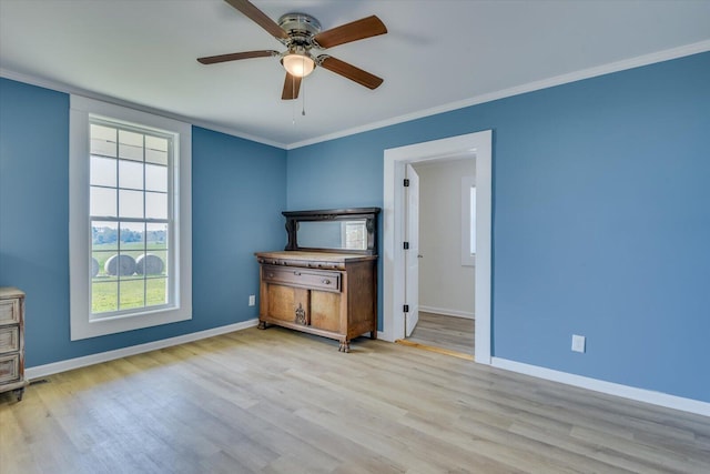 interior space featuring ceiling fan, light hardwood / wood-style floors, and ornamental molding