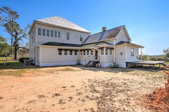 rear view of house featuring cooling unit