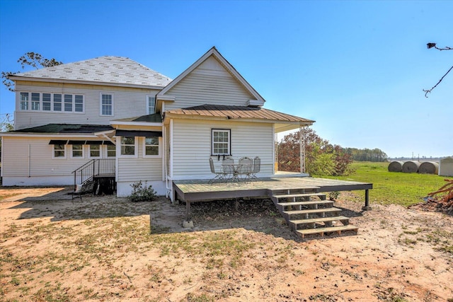 back of property with a wooden deck