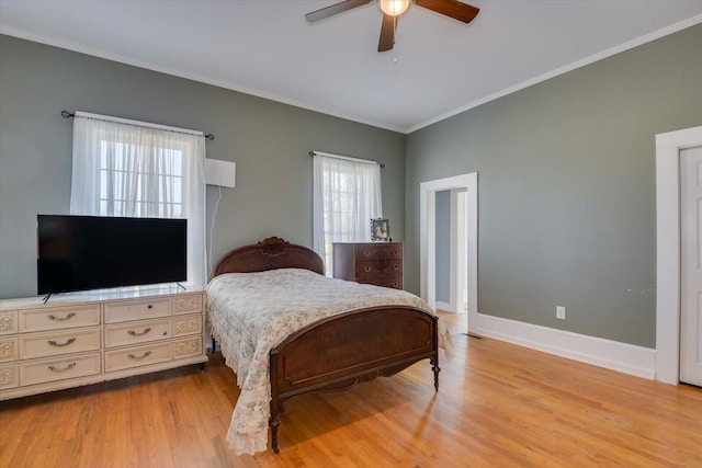bedroom featuring multiple windows, ceiling fan, light hardwood / wood-style flooring, and ornamental molding