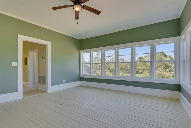 unfurnished sunroom featuring ceiling fan