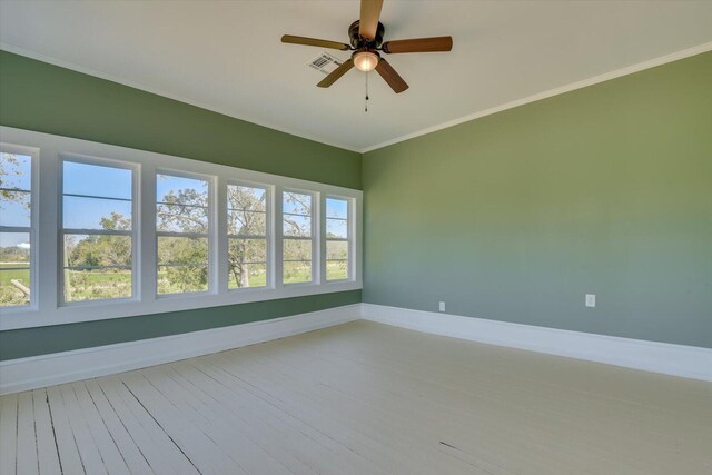 unfurnished room featuring hardwood / wood-style floors, ceiling fan, and crown molding