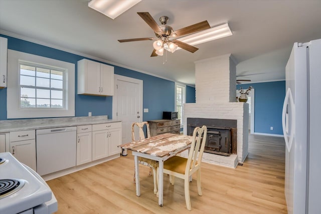 kitchen with white cabinets, ornamental molding, white appliances, and light wood-type flooring
