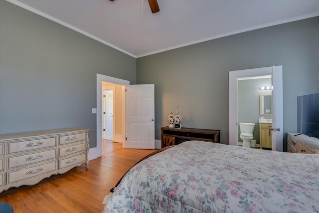 bedroom featuring ceiling fan, light hardwood / wood-style floors, ornamental molding, and ensuite bathroom
