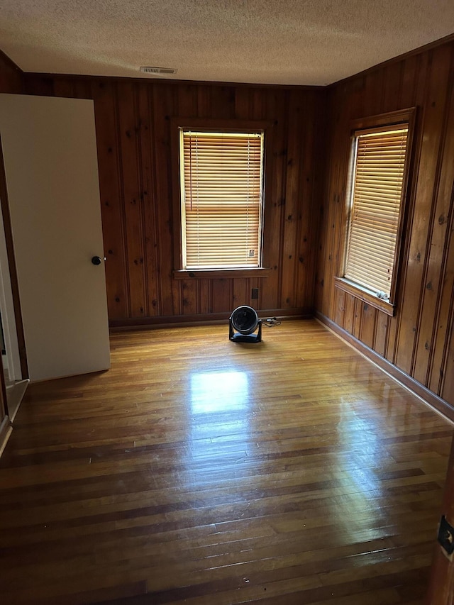 3007 Meadowbrook Dr, Augusta, GA 30906 - empty room featuring a textured ceiling, wood finished floors, and wood walls