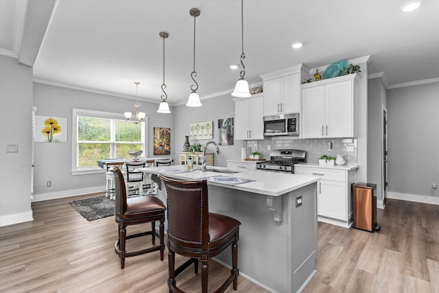 268 Anneswood Rd, Martinez, GA 30907 - kitchen with appliances with stainless steel finishes, a sink, an island with sink, light countertops, and decorative backsplash