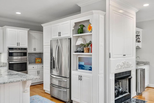 153 Longwood Green Ct, Aiken, SC 29803 - kitchen with appliances with stainless steel finishes, light stone counters, light wood-type flooring, and white cabinetry