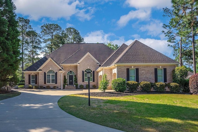 153 Longwood Green Ct, Aiken, SC 29803 - view of front facade featuring brick siding, a shingled roof, a front yard, and curved driveway