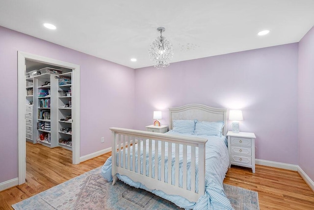 153 Longwood Green Ct, Aiken, SC 29803 - bedroom featuring baseboards, wood finished floors, and a chandelier